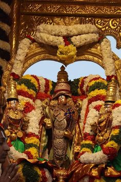 an idol is displayed in front of a crowd