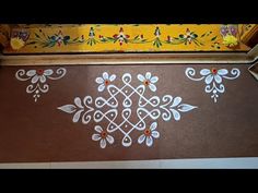 the floor is decorated with white and orange designs on brown carpeted tiles, along with an intricately designed border