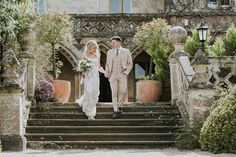 a bride and groom walking down the stairs