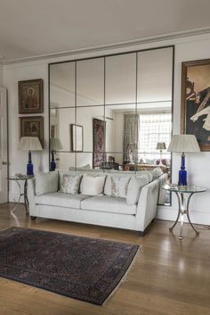 a living room filled with furniture and mirrors