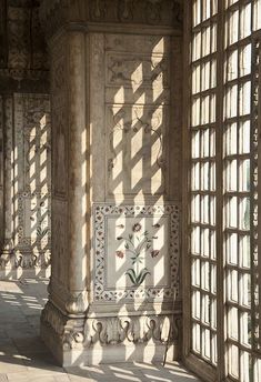 the sun shines through windows in an ornate building