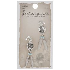 a pair of earrings with feathers hanging from it's ear hooks, on a card