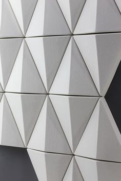 a white wall with many triangles on it