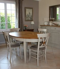 a dining room table with four chairs around it