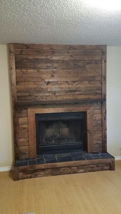 a living room with a fire place and wood paneling on the wall behind it