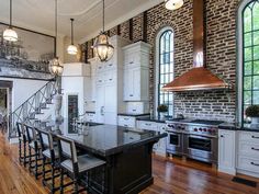 a large kitchen with an island in the middle and lots of counter space next to it