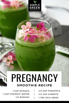 two glasses filled with green smoothie on top of a silver tray next to pink flowers