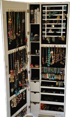 an open closet filled with lots of jewelry