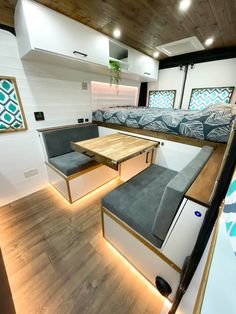 the interior of a camper with couches and tables on it's sides