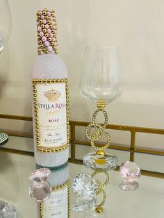 a bottle of wine sitting on top of a table next to a glass and other items