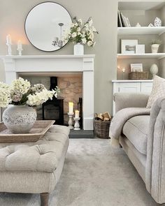 a living room filled with furniture and a fire place in front of a white fireplace