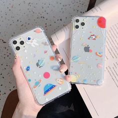 two cases with space and stars on them, one is holding an open book while the other