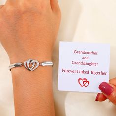 a mother and daughter bracelet with two hearts on it