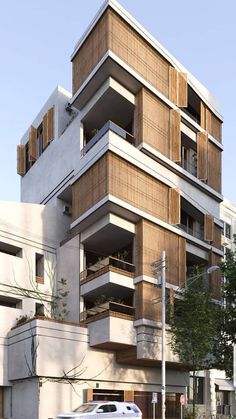 an apartment building with balconies on the top floor