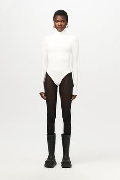 Our classic Fall and Winter bodysuit has arrived in a turtleneck design, long fitted sleeves and a bodycon finish. Thong cut in the back with snap closures down below. Pair this with your favorite bottoms to create casual or dressed up fits. Xx NW Collection Import 95% Polyester, 5% Spandex Model wears size X-Small in Black True to size This bodysuit is double-lined All Bodysuits Are Final Sale Fitted Sleek Turtleneck Bodysuit, Turtleneck Second-skin Bodysuit, Black High Neck Second-skin Bodysuit, Sleek High-stretch Bodysuit With Thumbholes, Second-skin Turtleneck Bodysuit With Thumbholes, Turtleneck Bodysuit, Womens Bodysuit, Sleek Fashion, Fashion Games