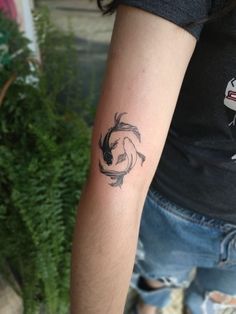 a woman's arm with a tattoo on it and a fish in the middle