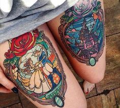 a woman's leg with some tattoos on her legs and the image of beauty and the beast