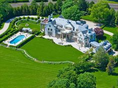 an aerial view of a large mansion with a pool