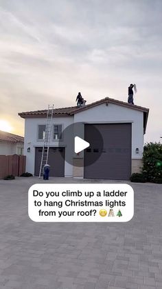 two men standing on top of a roof next to a house with the words do you climb up a ladder to hang christmas lights from your roof?