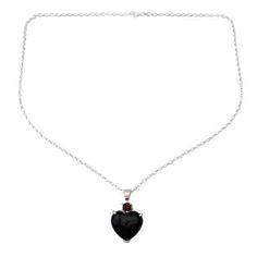 A sparkling garnet watches over an onyx heart in the powerful design of this necklace by Shanker. He crafts the sterling silver necklace by hand with the gems of love and protection. .925 Sterling silver Gothic Pendant Jewelry For Valentine's Day, Gothic Garnet Jewelry For Gift, Gothic Jewelry For Valentine's Day Formal, Gothic Gemstone Necklace For Gift, Gothic Heart-shaped Anniversary Jewelry, Black Heart-shaped Gemstone Jewelry, Black Heart Pendant Jewelry For Formal Occasions, Spiritual Black Heart-shaped Necklace, Gothic Sterling Silver Heart Pendant Jewelry