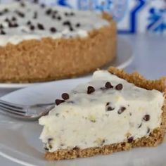 there is a piece of cake on the plate with a fork next to it and another pie in the background