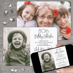 a person holding up a cell phone next to some cards and confetti on a table