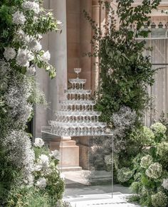 an elaborate glass display in the middle of a garden