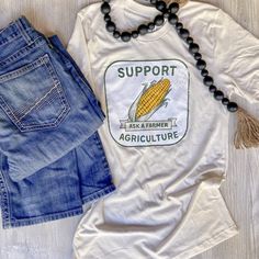 Tan tshirt that says support agriculture on it with a corn cob in the middle. Ask a Farmer Agriculture Tshirts, Roots Clothing, Farm Tshirt, Agriculture Industry, Western Style Outfits, Country Fashion, A Farmer, On The Farm, Clothing Co