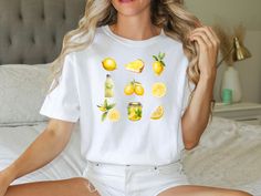 Introducing our zesty Comfort Color t-shirt featuring a refreshing lemon design. Made for those who crave a burst of brightness in their wardrobe, this tee combines comfort and style effortlessly. Crafted with the softest fabric and boasting a relaxed fit, it's perfect for adding a splash of citrus charm to your everyday look. Whether you're lounging at home or out and about, this lemon t-shirt is sure to add a sunny touch to any ensemble. Embrace the zest for life and elevate your wardrobe today! Each shirt is carefully printed with high-quality, eco-friendly inks, ensuring vivid colors that remain vibrant wash after wash. Whether you're exploring the farmer's market, enjoying a leisurely stroll, or simply lounging at home, this tee adds a touch of nature-inspired flair to any outfit. 🍋 Casual Lemon Tops For Summer, White Short Sleeve Top With Lemon Print, Trendy Fruit Print T-shirt For Summer, Relaxed Fit Fruit Print T-shirt For Spring, Short Sleeve Lemon Print Graphic Tee, Affordable Casual T-shirt With Fruit Print, Yellow Lemon Print T-shirt For Spring, Casual Summer T-shirt With Fruit Design, Summer Short Sleeve T-shirt With Fruit Design