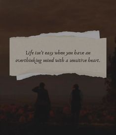 two people standing next to each other with a piece of paper in front of them that says life isn't easy when you have an overthing mind with a positive heart