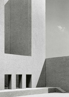 a black and white photo of a building with stairs leading up to the top floor