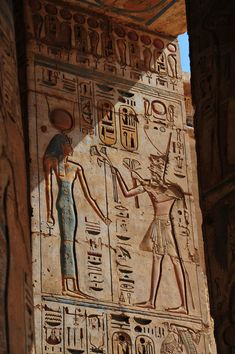 an ancient egyptian painting on the side of a building