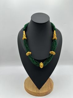 Introducing the exquisite "Nepalese Katar Gedi Hydro Potey Necklace" - a masterpiece inspired by the rich cultural heritage of Nepal. Handcrafted with love and skill by talented artisans, this necklace embodies the essence of Nepalese craftsmanship. Our company offers expedited Next-Day Delivery Services within the United Kingdom, ensuring prompt and efficient transportation of goods.  Additionally, we strive to extend our shipping capabilities to cater to customers worldwide, aiming to provide Green Artisan Jewelry For Wedding, Artisan Green Jewelry For Wedding, Artisan Green Wedding Jewelry, Temple Jewelry Style Green Emerald Necklace For Festive Occasions, Temple Jewelry Green Emerald Necklace For Festive Occasions, Green Temple Jewelry Necklace For Festivals, Green Emerald Temple Jewelry Necklace For Celebration, Traditional Round Beads Emerald Necklace For Festive Occasions, Green Round Beads Temple Necklace For Weddings