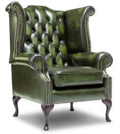 a green leather chair with nail polishing on the armrests and foot rest