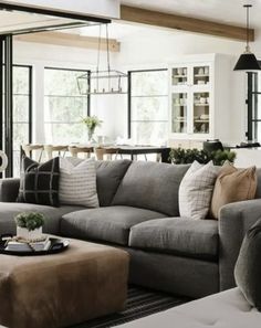 a living room filled with furniture and lots of windows