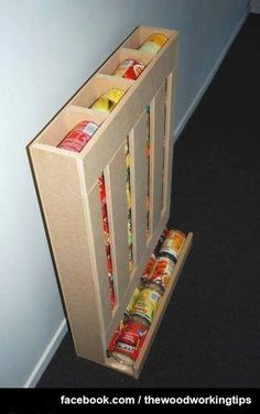 an open door with canned food in it next to a wall and carpeted floor