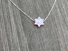 This beautiful Star of David /Magen David/Jewish Star Opal Necklace is sure to be someone's favorite. It's a great Bat Mitzvah or Hanukkah gift. Sterling Silver or 14kt Gold Filled Charm Size: 10mm Lab Created Opal Your Choice of Length and Color Chain Styles: 0.7mm Box Chain Disclaimer: Before placing an order for a necklace or bracelet, please ensure you measure your desired size carefully. Customers are fully responsible for choosing the correct length, as all cut chains are non-refundable. I Star Of David Charm Jewelry Gift, Hanukkah Gift Pendant Jewelry, White Star Of David Jewelry Gift, Sterling Silver Jewelry For Hanukkah Gifts, Star Of David Necklace For Hanukkah Gift, Hanukkah Gift Necklace With Star Of David, Spiritual Jewelry For Hanukkah Gift, Star Of David Necklace For Gift, Judaica Jewelry