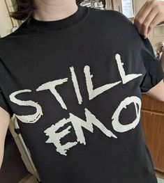 For the fellow eternally emo kids - first run of STILL EMO tees!  Unisex adult size Gildan 100% cotton t-shirts. Designed and printed in Memphis, TN Limited quantity and sizes for now, when these run out I will re-order and include larger sizes. Sorry for the inconvenience! Check out my shop for more emo kid stuff. ×FREE STICKERS WITH EVERY PURCHASE× ×FREE SHIPPING for overs over $35× Cheap Emo Short Sleeve Tops, Cheap Black Emo Tops, Cheap Black Emo T-shirt, Scene Kid Outfits, Emo T Shirt, Mall Goth Y2k, Emo Shirts, Black Tee Shirt, Scene Outfits