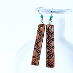 "These western leather earrings will make a stunning addition to your favorite outfit! These hand tooled earrings are hypoallergenic and are super lightweight. They include a turquoise color coconut shell bead to add a pop of color. This listing is for 1 pair of earrings. * Made from 100% full-grain leather * ONLY found at The Leather Smithy * Lightweight so they are comfortable to wear * Made with high-grade surgical stainless steel ear wires so they won't irritate your skin. Great for people w Adjustable Hand Tooled Drop Earrings, Western Leather Earrings, Tooled Leather Earrings, Western Bar, Diy En Cuir, Leather Jewelry Making, Handmade Bar, Handmade Leather Jewelry, Leather Tooling Patterns