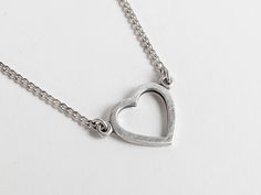 Infuse a dash of 90s charm into your accessory collection with this vintage heart pendant necklace. Beautifully crafted from silver (stamped on the back), this lovely piece features an openwork filigree heart outline hanging gracefully from a curb chain and fastens with a non-original, over-sized silver tone spring ring. Its minimalist design is ideal for adding a subtle statement to any outfit. This delightful necklace would serve as a heartfelt token of affection, making it a splendid love gif Everyday Metal Open Heart Necklace, Everyday Open Heart Metal Necklace, Everyday Metal Heart Pendant Charm Necklace, Everyday Metal Charm Necklace With Heart Pendant, Nickel-free Heart Necklace For Everyday Wear, Everyday Nickel-free Heart Shaped Necklaces, Everyday Heart-shaped Nickel-free Necklaces, Everyday Heart-shaped Nickel-free Necklace, Everyday Heart Shaped Nickel Free Necklace