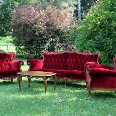 red velvet couches and chairs in the grass