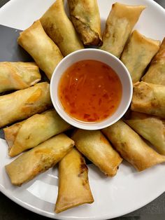 a white plate topped with food and dipping sauce