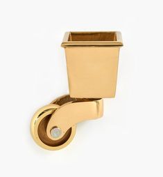 a gold toilet paper holder on a white background