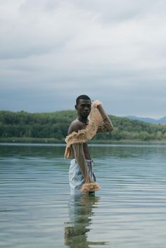 a man is standing in the water holding something