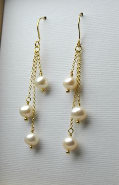 "A gorgeous and classy pair of earrings with high quality freshwater pearls that will be great for your wedding day, as a gift for your bridesmaids or any special woman in your life! They look perfect with every colour and outfit! - All earrings are sent to you with silicon backs. - Total length of the earrings: ~ 2.5 inches (6.5 cm) - You can choose between solid sterling silver, 14k yellow gold filled or 14k rose gold filled. PEARL PROPERTIES: * Offer optimism, vitality, wellness, health, long Pearl Chandelier Earrings With Pearl Chain As Gift, Dangle Pearl Drop Earrings, Pearl White Akoya Pearl Dangle Earrings, Akoya Pearl Drop Dangle Earrings, Akoya Pearl Dangle Earrings In Pearl White, Akoya Pearl Dangle Earrings, Akoya Pearl White Dangle Earrings, Graceful Pearl Earrings With Pearl Pendant, Akoya Pearl Dangle Earrings For Anniversary