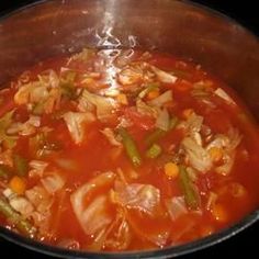 a pot filled with soup and vegetables on top of a stove