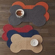 three placemats and a bowl on a wooden floor with a dog's food dish