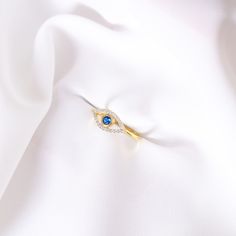 Your Solid Gold Sapphire Eye Band Ring is stylish, dainty and pretty ideal for everyday use. Details of solid gold handmade Good Luck Eye Ring are very eye-catching. It is a great gift for your loved ones. This jewelry will be an indispensable piece of yours. This meaningful Diamond Devil Eye Ring with high quality handwork will be a legacy you can leave to your family its.  * Sapphire Evil Eye Ring Details * Material / Gold Kt : This elegant ring is made of 14k and 18k Solid Gold * Available Go Elegant Rings With Diamond Eyes For Anniversary, Elegant Ring With Diamond Eyes For Anniversary, Gift Sapphire Ring With Pave Setting In Cubic Zirconia, Gold Rings With Diamond Eyes For Anniversary, Gold Rings With Diamond Eyes For Promise, Fine Jewelry Diamond Eyes Rings For Gifts, Gold Promise Ring With Diamond Eyes, Elegant Diamond Ring With Diamond Eyes For Promise, Gold Sapphire Ring With Cubic Zirconia Gift