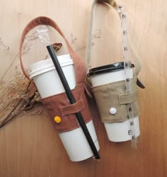 two coffee cups sitting next to each other on top of a wooden table