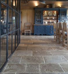 a dining room with blue cabinets and chairs